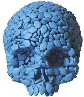 Pile of blue ED pills arranged in a skull shape, representing the risks of relying on prescription medication alone